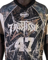 Close-up of the "TRUST ISSUE 47" graphic on the GRITMESH 47 oversized mesh jersey featuring perforated mesh fabric and distressed typography.